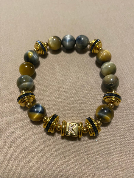 Gold and blue tigers eye beads with gold initial accents.
