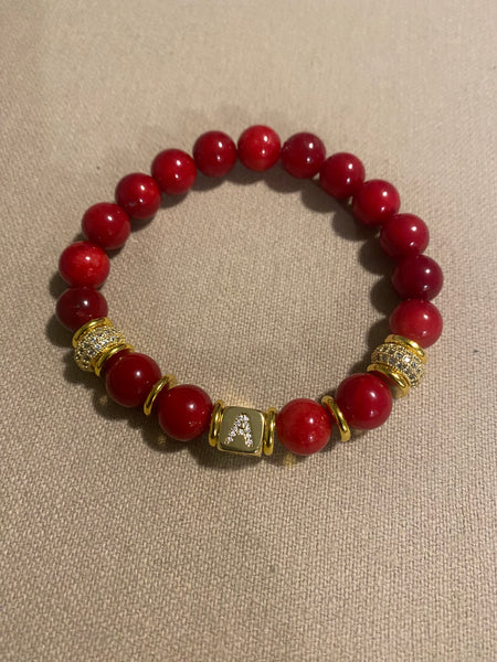 Red bamboo beads with gold Initial accent bead in gold accents